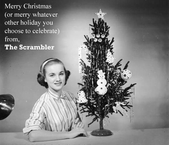 a Christmas card from the Scrambler. Image with girl next to Christmas tree.